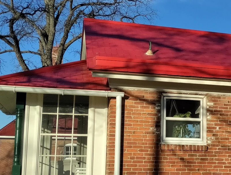 metal roof with white gutters Conroe